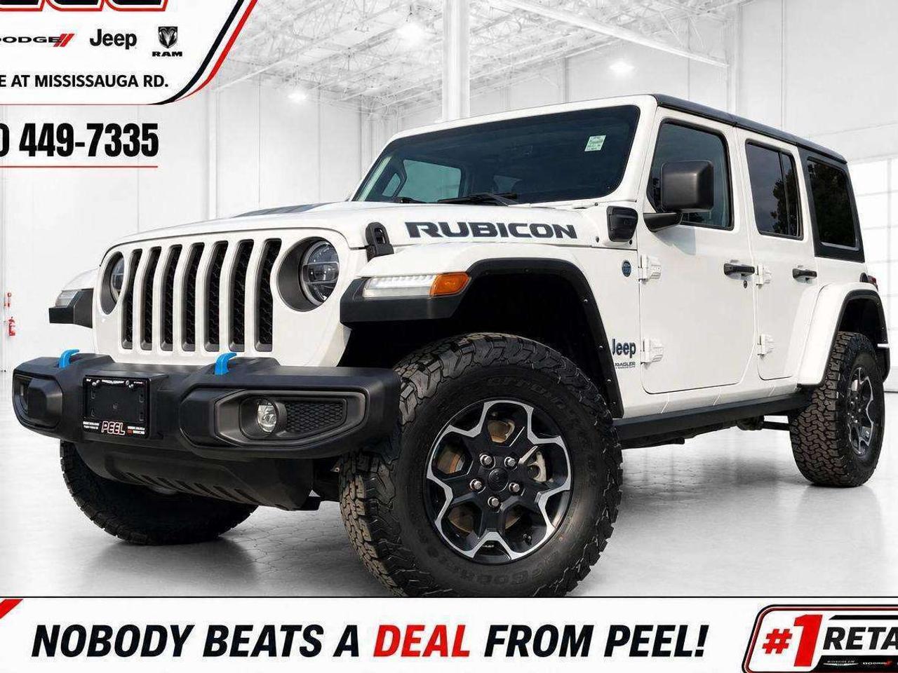 COME SEE WHY NOBODY BEATS A DEAL FROM PEEL! Your Source for ALL make and models used cars and trucks. 2022 Jeep Wrangler Unlimited Rubicon 4xe 4X4 | Plug-In Hybrid 2.0L Turbo Engine | Bright White | Ontario Green Plate Eligible | Heated Leather-Faced Seats | Uconnect 8.4-Inch Touchscreen Display with Navigation | Alpine Premium Audio System | Black Freedom 3-Piece Hard Top | Heated Steering Wheel | Remote Start | Apple CarPlay & Android Auto | ParkView Rear Back-Up Camera | Front & Rear Locking Differentials | Electronic Sway Bar Disconnect | 4.10 Axle Ratio | LED Lighting Group | Gorilla Glass Windshield | Class II Hitch Receiver | 4 & 7-Pin Trailer Wiring | Auxiliary Switches | Body-Colour Highline Flares This 2022 Jeep Wrangler Unlimited Rubicon 4xe gives you the real Jeep experience with plug-in hybrid efficiency, helping reduce fuel use on everyday driving while preserving the trail-ready confidence Rubicon buyers expect. Ontario Green Plate eligibility adds a meaningful commuter advantage, while the 2.0L turbo plug-in hybrid powertrain delivers responsive performance both on the road and when the pavement ends. Heated leather-faced seats, a heated steering wheel, remote start, Alpine premium audio, and the Uconnect 8.4-inch navigation touchscreen make it easy to enjoy year-round, while the Black Freedom 3-piece hard top keeps the open-air Jeep lifestyle front and centre. Front and rear locking differentials, an electronic sway bar disconnect, 4.10 gearing, LED lighting, Gorilla Glass windshield, body-colour Highline fender flares, and a Class II hitch with 4 and 7-pin wiring make this a properly equipped Rubicon that delivers savings during the week and serious capability when adventure calls. ______________________________________________________ FREE CarFax included! Click the CarFax link in the listing to view the report. Our advertised prices are for consumers/end users only and are not intended for dealer, wholesale, exporter, or broker purchases. ______________________________________________________ Peel Chrysler is based in Port Credit, Mississauga, and proudly serves customers across Ontario and Canada, including Toronto, Oakville, North York, Richmond Hill, Ajax, Hamilton, Niagara Falls, Brampton, Scarborough, Vaughan, London, Windsor, Cambridge, Kitchener, Waterloo, Brantford, Sarnia, Pickering, Huntsville, Milton, Woodbridge, Aurora, Newmarket, Orangeville, Georgetown, Markham, North Bay, Sudbury, Barrie, Oshawa, Kingston, Innisfil, and surrounding areas. Browse our selection of used cars, trucks, SUVs, vans, Ram, Jeep, Dodge, Chrysler, FIAT, and all makes and models at peelchrysler.com. ______________________________________________________ Disclaimer: Prices are for consumer/end-user purchases only. Advertised prices are all-in and include all dealer fees and charges, including the $599 loan processing fee where applicable, except HST, Fuel and Licensing, unless otherwise stated. Payments, rates, and terms are subject to approved credit and may change without notice. If a trade-in has an outstanding loan balance and Peel Chrysler is required to facilitate the lien payout, a $349 lien payout fee applies. Most pre-owned vehicles originally come with two keys; however, all Peel Chrysler pre-owned vehicles come standard with one key unless otherwise stated. Vehicle images may be digitally adjusted or enhanced for presentation purposes and may not always reflect the exact appearance of the vehicle. While we make every effort to ensure accuracy, vehicle details, features, options, materials, history, specifications, pricing, availability, and CarFax information should be verified with Peel Chrysler before purchase.