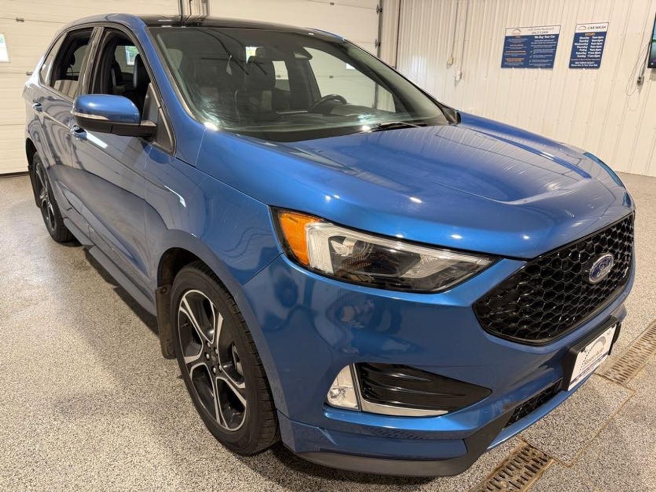 <p data-start=0 data-end=538>Twin-Turbo Performance Meets Premium SUV Comfort</p><p data-start=0 data-end=538><br data-start=53 data-end=56> Experience exhilarating performance and everyday practicality with this 2021 Ford Edge ST AWD! Powered by a powerful 2.7L twin-turbo V6 paired with a smooth automatic transmission, this Edge ST delivers impressive power and confident handling while the AWD system provides excellent traction and stability in changing road conditions. Whether youre commuting, heading out on a road trip, or simply enjoying the open road, this Edge ST brings a sporty feel to the SUV segment.<span aria-hidden=true></span></p><p data-start=540 data-end=1433>Step inside and enjoy a premium, technology-filled cabin designed for comfort and convenience. Power-adjustable front seats with three-position memory settings, heated front seats, and a heated steering wheel keep you comfortable year-round, while dual-zone climate control allows personalized temperatures for driver and passenger. Remote start, push-button start, and keyless entry add everyday convenience, while Bluetooth and USB connectivity keep your devices connected. Rear USB charging ports help keep passengers devices powered on longer trips. Apple CarPlay and Android Auto are integrated through the touchscreen infotainment system, while built-in navigation helps guide your travels. The panoramic sunroof stretches across the front and rear seating areas, filling the cabin with natural light, while the power liftgate makes loading cargo quick and convenient.</p><p data-start=1435 data-end=2255>This Edge ST is also equipped with an impressive list of advanced safety and driver assistance features. Adaptive cruise control, lane keep assist, blind spot monitoring, forward collision warning, automatic emergency braking, and rear cross traffic alert help provide added confidence on every drive. Auto-dimming high beams and rain-sensing wipers further enhance convenience, while parking sensors and a backup camera make maneuvering easier. When you need to tow, the factory tow package provides up to 3,500 lbs of towing capacity, making this sporty SUV surprisingly capable for hauling trailers and recreational equipment. Powerful, luxurious, and packed with technology, this 2021 Ford Edge ST is an outstanding choice for drivers looking for performance without giving up everyday practicality.</p><p data-start=2257 data-end=2292>Includes two keys and block heater.</p><p data-start=2294 data-end=2744>At Sisson Auto, we make buying a vehicle a seamless and stress-free experience. Our transparent pricing eliminates haggling and eliminates any hidden fees. To give you peace of mind, we offer a 3-day/600 km No-Hassle Return Policy, a 30-day exchange privilege, minimum warranties with 24-hour roadside assistance, a check for safety recalls, and a complimentary CarFax history report. Plus, home delivery is free within 200 km. Dealer permit #5471.</p><p> </p><p data-start=2746 data-end=2931 data-is-last-node= data-is-only-node=>** This description was written by AI based on information provided about the vehicle. AI can sometimes produce incorrect information. Please confirm all details with the dealership. **</p>