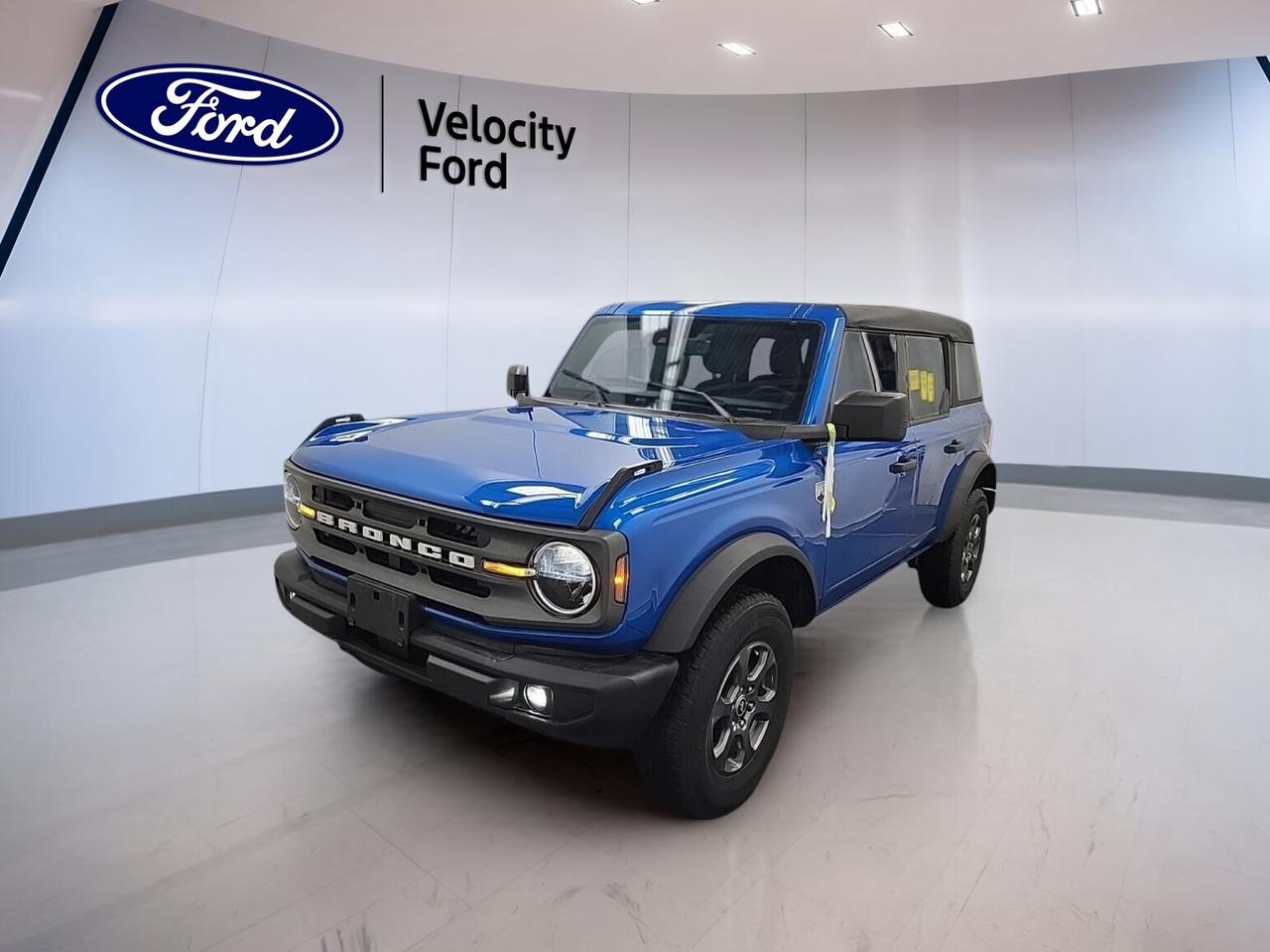 Meet the 2024 Ford Bronco Big Bend 4 Door 4x4, a used SUV built for real adventure and everyday ease. Offered by Velocity Ford in Moose Jaw, this Blue Bronco pairs rugged style with proven capability. With 28,304 km, a 2.3-litre unleaded engine, and automatic transmission, it is ready for work, weekends, and every road in between.

The Black interior keeps the cabin clean and practical, while the four-door layout adds easy access for passengers and gear. This Bronco Big Bend 4 Door 4x4 also brings classic open-air freedom with its convertible design, plus off-road confidence from four-wheel drive and off-road tires.

FEATURES OF THE Bronco Big Bend 4 Door 4x4

»» Four-door body with removable roof design
»» Standard four-wheel drive for rough terrain
»» Big Bend trim balances comfort, utility
»» Off-road focus with everyday usability built-in

ADVANCED SAFETY FEATURES

»» Anti-lock braking system helps maintain control
»» Stability control supports confident road handling
»» Backup camera aids reversing in tight spaces
»» Multiple airbags help protect occupants well

PERFORMANCE AND EFFICIENCY

»» 2.3-litre engine delivers solid everyday power
»» Automatic transmission supports smooth shifting performance
»» Four-wheel drive improves traction off-road
»» Off-road tires enhance grip on trails

COMFORT AND CONVENIENCE

»» Cruise control helps on longer drives
»» Front air conditioning keeps cabin comfortable
»» Power windows add daily ease
»» Heated mirrors help in cold weather

TECHNOLOGY AND CONNECTIVITY

»» Bluetooth integration supports hands-free calling
»» WiFi hotspot keeps devices connected
»» Steering wheel audio controls add convenience
»» Satellite radio expands entertainment choices

CARGO SPACE

»» Rear trunk access simplifies loading gear
»» Four-door layout improves cargo flexibility
»» Spare tire adds travel reassurance
»» Cabin offers room for passengers, essentials

AWARDS & RECOGNITIONS

»» Best-in-class off-road reputation, The Car Guide, 2024
»» Top resale value honour, Canadian Black Book, 2024

WHAT OTHER OWNERS LIKE

»» Confident off-road ability in varied conditions
»» Easy open-air driving with convertible design
»» Practical four-door access for daily use
»» Strong blend of comfort and toughness

This 2024 Ford Bronco Big Bend 4 Door 4x4 stands out with useful features that drivers want most. It includes power steering, power mirrors, tinted windows, push button start, fog lights, automatic headlights, tire pressure monitoring, child safety locks, passenger airbag sensor, illuminated vanity mirrors, and rear tow hook capability for added utility.

The leather-wrapped steering wheel adds a refined touch to the durable cabin without taking away from the Broncos practical nature. Electric mirrors and automatic door locks make daily use simple, while LED headlamps help improve visibility in changing weather and darker rural roads around Moose Jaw.

If you want an SUV that feels at home on the highway, in town, or beyond the pavement, this 2024 Ford Bronco Big Bend 4 Door 4x4 delivers the right mix of toughness, function, and comfort. It is a smart choice for drivers who value true utility, proven Ford engineering, and iconic Bronco character.

This 2024 Ford Bronco Big Bend 4 Door 4x4s VIN is: 1FMDE7BH7RLA12507.