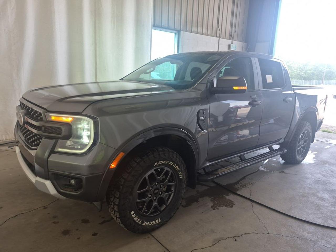 THE PRICE YOU SEE, PLUS GST. GUARANTEED!APPLE CARPLAY/ANDROID AUTO COMPATABLE! 2.3 LITER ECOBOOST, 10 SPEED AUTO, XLT TRIM(301a), EBONY PREMIUM CLOTH SEATS, POWER SLIDING REAR WINDOW, SPORT APPEARANCE PKG, PRO-TRAILER BACK UP ASSIST, TRAILER TOW PKG, SPRAY IN LINER, FX-4 OFF-ROAD PKG, BLACK RUNNING BOARDS, INTEGRATED BOX SIDE STEP, SYNC 4, BLIS W/CROSS-TRAFFIC ALERT, FORD PASS CONNECT, REMOTE START, TOW HOOKS     The 2024 Ford Ranger XLT with the FX4 Off-Road Package, Trailer Tow Package, and 301A Package is a highly capable and well-equipped midsize pickup designed to excel both on and off the road. The FX4 Off-Road Package enhances the Rangers off-road performance with features such as skid plates, off-road-tuned suspension, terrain management system, and all-terrain tires, making it adept at tackling rugged trails and challenging terrains. The Trailer Tow Package adds valuable towing capabilities, including a Class IV hitch receiver, trailer sway control, and an integrated trailer brake controller, allowing the truck to handle heavier loads with confidence. The 301A Package boosts the interior with comfort, convenience, and technology features, including a larger touchscreen infotainment system, premium audio, upgraded upholstery, and additional driver-assistance systems to improve safety and ease of driving. Overall, the 2024 Ford Ranger XLT with these packages offers a versatile blend of off-road prowess, towing capacity, and modern amenities, making it an excellent choice for outdoor enthusiasts, weekend warriors, and practical daily drivers seeking a capable and comfortable midsize truck.Do you want to know more about this vehicle, CALL, CLICK OR COME ON IN!*AMVIC Licensed Dealer; CarFax and Full Mechanical Inspection Included.