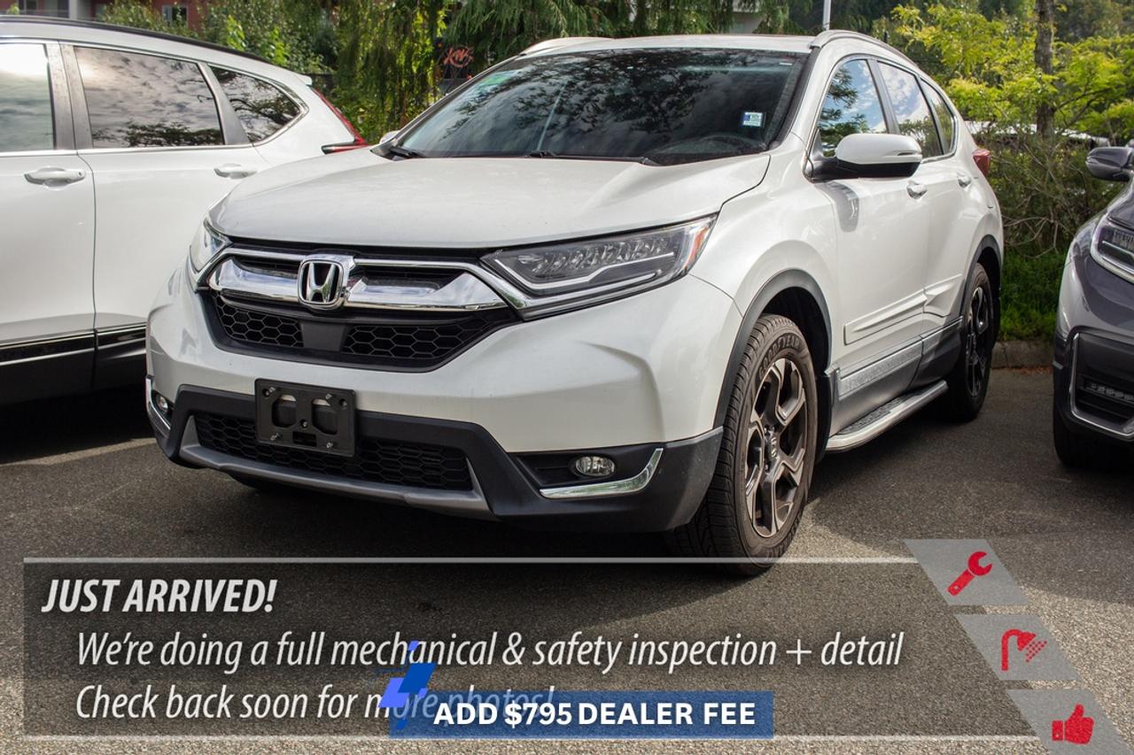 2019 Honda CR-V Touring AWD  Premium Comfort and All-Weather VersatilityThe 2019 Honda CR-V Touring AWD combines a versatile SUV cabin with upscale Touring features and confident all-wheel-drive capability. Its well suited to commuting around Port Moody and Coquitlam, navigating rainy Metro Vancouver roads, or loading up for a weekend beyond the city.### Key highlights include:* 1.5L turbocharged 4-cylinder engine* Real Time AWD with Intelligent Control System* Leather-trimmed seating* Heated front seats* Heated leather-wrapped steering wheel* Power-adjustable front seats* Drivers seat memory* Power moonroof* Hands-free power tailgate* Honda Satellite-Linked Navigation System* Apple CarPlay and Android Auto* Premium audio system* Wireless smartphone charging* Honda Sensing safety technologies* Blind Spot Information system* Rear Cross Traffic Monitor* Multi-angle rearview camera* Remote engine start* Proximity key entry with push-button start* Dual-zone automatic climate control* LED headlights* 18-inch alloy wheels* 60/40 split-folding rear seatsTouring trim adds the comfort and convenience buyers appreciate on longer drives, while the CR-Vs flexible cargo area makes room for groceries, luggage, sports equipment, or weekend gear.Real Time AWD provides added confidence through Metro Vancouver rain and changing BC road conditions. The turbocharged engine also delivers responsive everyday performance without requiring a large SUV footprint.Every Westwood Honda used vehicle is supported by our **BuySmart Program**, including a **Full CarProof vehicle history report**, **Mechanical inspection**, **2-month / 5,000km powertrain warranty**, **6-month tire, brake, battery, and bulb coverage**, **Professional detailing**, **Full tank of gas or full EV charge**, and **Market-based no-haggle pricing**. **Book your test drive at Westwood Honda in Port Moody today.****Apply for financing online today.****Ask us about your trade-in.**### FAQs**Q: Is the 2019 CR-V Touring AWD good for BC winters?**A: AWD adds confidence in rain and changing winter road conditions when paired with appropriate tires.**Q: Does the Touring have leather seating?**A: Yes, Touring includes leather-trimmed seating.**Q: Does it have navigation?**A: Yes, Touring includes Honda navigation.**Q: Does it support Apple CarPlay and Android Auto?**A: Yes, both are supported.**Q: Is the CR-V good for Sea-to-Sky trips?**A: Its AWD, cargo flexibility, and comfortable cabin suit weekend trips beyond Vancouver.**Q: Can I trade in my current vehicle?**A: Yes. Westwood Honda offers trade-in appraisals in Port Moody.