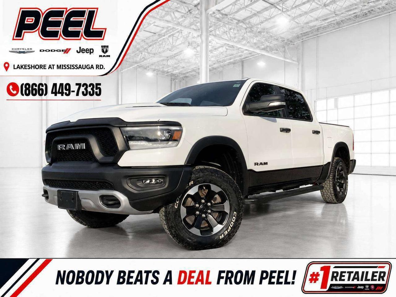 COME SEE WHY NOBODY BEATS A DEAL FROM PEEL! Your Source for ALL make and models used cars and trucks.

2021 Ram 1500 Rebel Crew Cab 4X4 | 5.7L HEMI V8 | Bright White | Low Kilometres | Heated Front Seats | Heated Steering Wheel | Uconnect 8.4-Inch Touchscreen Display | Apple CarPlay & Android Auto | Forward Collision Warning with Active Braking | Rear Back-Up Camera | 3.92 Rear Axle Ratio | Electronic Locking Rear Differential | Rebel Sport Performance Hood | Class IV Hitch Receiver | 7-Pin Trailer Wiring | Spray-In Bedliner | Second-Row In-Floor Storage | 18-Inch Mid-Gloss Black Wheels

This 2021 Ram 1500 Rebel comes finished in Bright White and is powered by the legendary 5.7L HEMI V8, giving you the classic Mopar power, sound, and 4X4 confidence that make a Rebel such a desirable truck. With very low kilometres, it is an excellent opportunity to get into a well-kept HEMI Rebel without paying for unnecessary luxury extras. Its purpose-built setup includes the Rebel sport performance hood, 3.92 rear axle ratio, electronic locking rear differential, and 18-inch black wheels for the aggressive look and real capability buyers expect. Heated front seats, a heated steering wheel, the 8.4-inch Uconnect touchscreen, Apple CarPlay, Android Auto, forward collision warning with active braking, and a rear camera provide the everyday comfort and technology that matter most. The added spray-in bedliner, Class IV hitch receiver, 7-pin trailer wiring, and second-row in-floor storage make it ready for work, towing, and weekend gear. This is a clean, low-kilometre Rebel with the right options and true HEMI truck character.
______________________________________________________

FREE CarFax included! Click the CarFax link in the listing to view the report.

Our advertised prices are for consumers/end users only and are not intended for dealer, wholesale, exporter, or broker purchases.
______________________________________________________

Peel Chrysler is based in Port Credit, Mississauga, and proudly serves customers across Ontario and Canada, including Toronto, Oakville, North York, Richmond Hill, Ajax, Hamilton, Niagara Falls, Brampton, Scarborough, Vaughan, London, Windsor, Cambridge, Kitchener, Waterloo, Brantford, Sarnia, Pickering, Huntsville, Milton, Woodbridge, Aurora, Newmarket, Orangeville, Georgetown, Markham, North Bay, Sudbury, Barrie, Oshawa, Kingston, Innisfil, and surrounding areas. Browse our selection of used cars, trucks, SUVs, vans, Ram, Jeep, Dodge, Chrysler, FIAT, and all makes and models at peelchrysler.com.
______________________________________________________

Disclaimer: Prices are for consumer/end-user purchases only. Advertised prices are all-in and include all dealer fees and charges, including the $599 loan processing fee where applicable, except HST, Fuel and Licensing, unless otherwise stated. Payments, rates, and terms are subject to approved credit and may change without notice. If a trade-in has an outstanding loan balance and Peel Chrysler is required to facilitate the lien payout, a $349 lien payout fee applies. Most pre-owned vehicles originally come with two keys; however, all Peel Chrysler pre-owned vehicles come standard with one key unless otherwise stated. Vehicle images may be digitally adjusted or enhanced for presentation purposes and may not always reflect the exact appearance of the vehicle. While we make every effort to ensure accuracy, vehicle details, features, options, materials, history, specifications, pricing, availability, and CarFax information should be verified with Peel Chrysler before purchase.