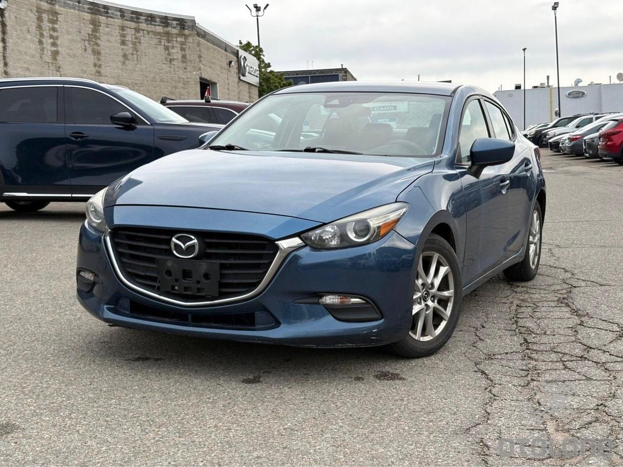 <h2 role=heading data-sfc-cp= data-sfc-root=ep>2018 Mazda Mazda3 GX &ndash; $9,999 (+ HST & Licensing)<!--TgQPHd|||[]--></h2><div data-sfc-cp= data-sfc-root=ep><span data-sfc-cp= data-sfc-root=ep>LOW KMS | Blue on Black | Sporty, Reliable & Highly Fuel-Efficient<!--TgQPHd|||[]--></span> 💙🔥<!--TgQPHd|||[]--></div><div data-sfc-cp= data-sfc-root=ep>🔥 <span data-sfc-cp= data-sfc-root=ep>The Best Perks<!--TgQPHd|||[]--></span><!--TgQPHd|||[]--></div><div data-sfc-cp= data-sfc-root=ep><ul><li data-sfc-cp= data-sfc-root=ep>🎁&nbsp;<span data-sfc-cp= data-sfc-root=ep>FREE<!--TgQPHd|||[]--></span> Professional Rust Proofing included!<!--TgQPHd|||[]--></li><li data-sfc-cp= data-sfc-root=ep>🎁 <span data-sfc-cp= data-sfc-root=ep>FREE<!--TgQPHd|||[]--></span> Fresh Oil Change included!<!--TgQPHd|||[]--></li></ul><!--TgQPHd|||[]--></div><div data-sfc-cp= data-sfc-root=ep>💰 <span data-sfc-cp= data-sfc-root=ep>UNBEATABLE VALUE:<!--TgQPHd|||[]--></span><!--TgQPHd|||[]--></div><div data-sfc-cp= data-sfc-root=ep><ul><li data-sfc-cp= data-sfc-root=ep><span data-sfc-cp= data-sfc-root=ep>Price:<!--TgQPHd|||[]--></span> $9,999 + HST & Licensing<!--TgQPHd|||[]--></li><li data-sfc-cp= data-sfc-root=ep><span data-sfc-cp= data-sfc-root=ep>Safety Certification:<!--TgQPHd|||[]--></span> Available for an extra $599<!--TgQPHd|||[]--></li><li data-sfc-cp= data-sfc-root=ep><span data-sfc-cp= data-sfc-root=ep>Warranty:<!--TgQPHd|||[]--></span> 6-Month Engine & Transmission cover for only $299!<!--TgQPHd|||[]--></li></ul><!--TgQPHd|||[]--></div><div data-sfc-cp= data-sfc-root=ep>📅 <span data-sfc-cp= data-sfc-root=ep>VIEWING BY APPOINTMENT ONLY<!--TgQPHd|||[]--></span><br data-sfc-root=ep data-sfc-pl=|||[]>📞 <span data-sfc-cp= data-sfc-root=ep>CALL/TEXT KAPIL:<!--TgQPHd|||[]--></span> 437-766-1844<br data-sfc-root=ep data-sfc-pl=|||[]>📍 <span data-sfc-cp= data-sfc-root=ep>LOCATION:<!--TgQPHd|||[]--></span> 9074 Wellington Rd 124, Hillsburgh, ON<!--TgQPHd|||[]--></div><div data-sfc-cp= data-sfc-root=ep><span data-sfc-cp= data-sfc-root=ep><!--TgQPHd|||[]--></span><br data-sfc-root=ep data-sfc-pl=|||[]><em data-sfc-root=ep>Note: Since we offer this vehicle at a rock-bottom wholesale price before safety, OMVIC regulations require us to include this standard legal statement:<!--TgQPHd|||[]--></em><!--TgQPHd|||[]--></div><div data-sfc-cp= data-sfc-root=ep><span data-sfc-cp= data-sfc-root=ep>OMVIC Mandatory Disclosure:<!--TgQPHd|||[]--></span> This vehicle is being sold as-is, unfit, not e-tested and is not represented as being in road worthy condition, mechanically sound or maintained at any guaranteed level of quality. The vehicle may not be fit for use as a means of transportation and may require substantial repairs at the purchaser&rsquo;s expense. It may not be possible to register the vehicle to be driven in its current condition.<!--TgQPHd|||[]--></div><hr data-sfc-root=ep data-sfc-pl=|||[]><div data-sfc-cp= data-sfc-root=ep>This sharp Mazda3 listing is ready to use! Send over the <span data-sfc-cp= data-sfc-root=ep>specs for your next vehicle<!--TgQPHd|||[]--></span> whenever you are ready.<!--TgQPHd|||[]--></div><div data-sfc-root=ep><br><!--TgQPHd|||[]--></div><div data-sfc-root=ep><!--TgQPHd|||[]--></div><div data-sfc-root=ep><!--TgQPHd|||[]--></div>