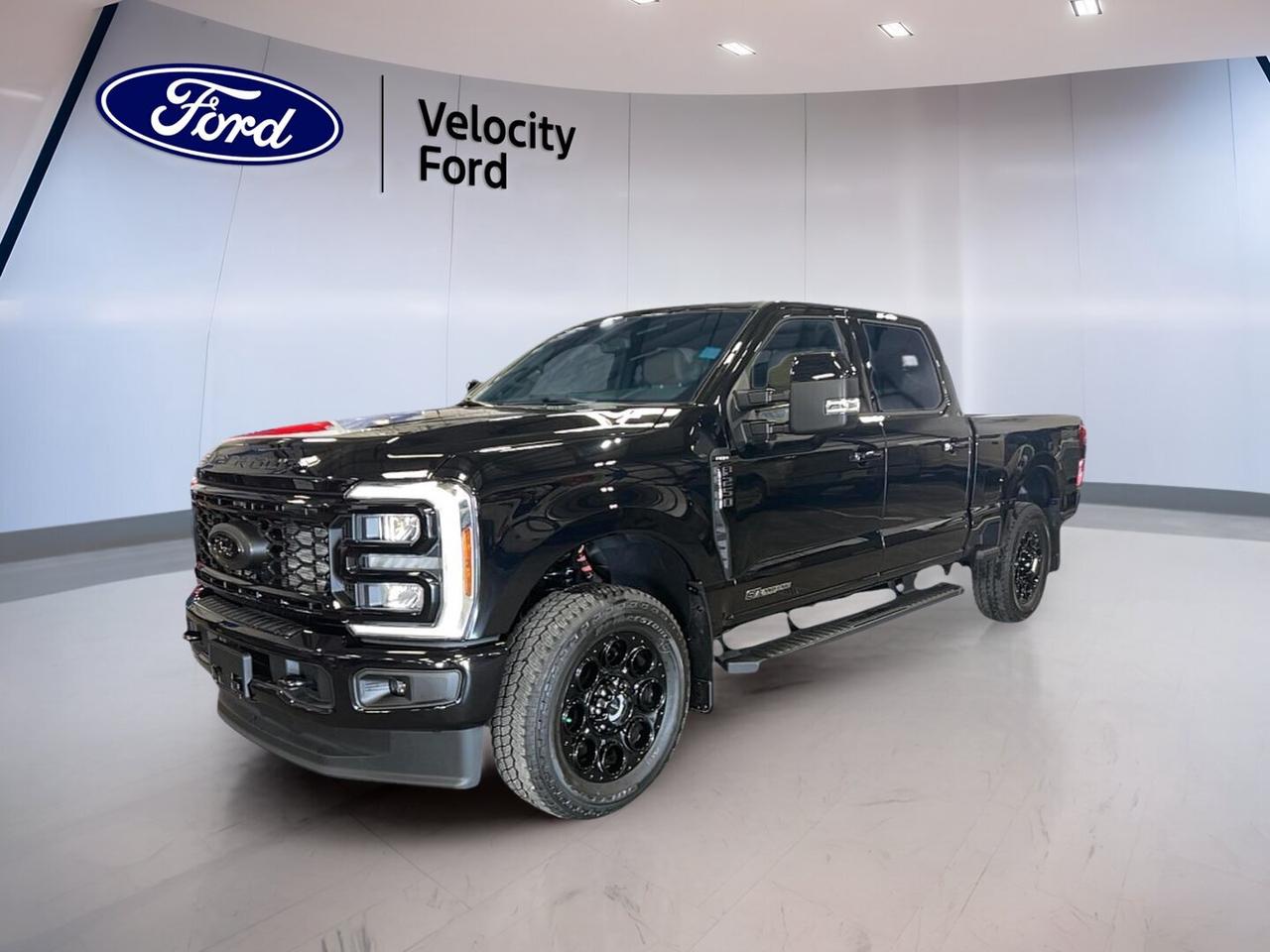 Meet the brand new 2026 Ford Super Duty F-250 SRW LARIAT 4WD Crew Cab 6.75 Box at Velocity Ford in Moose Jaw. Built for hard work and long days, this heavy-duty truck pairs a bold Black exterior with a Black interior, four full doors, automatic transmission, and a powerful 6.7-litre diesel engine.

The 2026 Ford Super Duty F-250 SRW LARIAT 4WD Crew Cab 6.75 Box is made for drivers who need real capability without giving up comfort. It brings strong towing confidence, advanced driver support, and smart cabin features that help make every trip, job, and haul easier in every season.

FEATURES OF THE Super Duty F-250 SRW LARIAT 4WD Crew Cab 6.75 Box

»» Crew Cab adds roomy rear seating
»» LARIAT trim blends work and comfort
»» 6.75-foot box supports versatile hauling
»» Diesel power brings serious pulling strength

ADVANCED SAFETY FEATURES

»» Anti-lock brakes help maintain control
»» Stability control supports secure handling
»» Blind spot monitor boosts lane awareness
»» Backup camera aids reversing confidence

PERFORMANCE AND EFFICIENCY

»» 6.7-litre diesel delivers strong torque
»» Automatic transmission shifts with smooth response
»» Four-wheel drive improves traction year-round
»» Limited slip differential aids uneven surfaces

COMFORT AND CONVENIENCE

»» Heated front seats add cold-weather comfort
»» Dual-zone climate control helps cabin comfort
»» Remote starter adds daily convenience
»» Power seats include lumbar support

TECHNOLOGY AND CONNECTIVITY

»» Navigation system helps guide every route
»» Bluetooth integration supports hands-free calling
»» Wi-Fi hotspot keeps devices connected
»» Steering wheel audio controls simplify use

TRUCK FEATURES

»» Towing capacity reaches 6,395 kg
»» Rear tow hook supports jobsite utility
»» Retractable mirrors help towing visibility
»» Spare tire adds roadside reassurance

CARGO SPACE

»» 6.75-foot box handles gear with ease
»» Crew Cab balances passengers and cargo
»» Rear trunk access listed for convenience
»» Wide bed suits tools and supplies

WHAT OTHER OWNERS LIKE

»» Strong diesel torque for heavy jobs
»» Comfortable cabin for long workdays
»» Confident towing with four-wheel drive
»» Useful tech for daily driving

Inside, this truck is set up for comfort and control. You get front air conditioning, automatic climate control, tinted windows, adjustable pedals, an adjustable steering wheel, memory seats, memory mirrors, heated and power mirrors, power windows, push button start, and an auto-dimming rearview mirror.

Driver-focused features help this truck feel ready for both work and travel. Automatic headlights, LED headlamps, fog lights, turn signal mirrors, tire pressure monitoring, cruise control, power steering, and dual shift mode transmission all add to the everyday ease of using this capable heavy-duty pickup.

Entertainment and connectivity are also well covered. Satellite radio, HD Radio, Bluetooth integration, Wi-Fi hotspot, and a navigation system help keep every drive informed and connected. Safety is supported by driver and passenger airbags, side impact airbags, head side airbags, child safety locks, and a passenger airbag sensor.

This 2026 Ford Super Duty F-250 SRW LARIAT 4WD Crew Cab 6.75 Boxs VIN is: 1FT7W2BTXTEF42875.