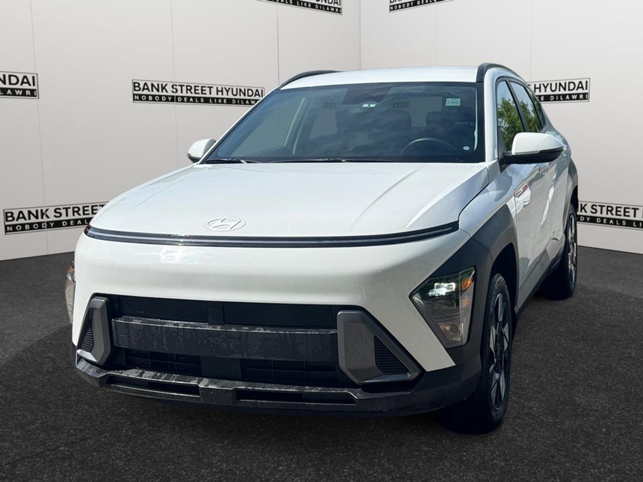 Explore the 2024 Hyundai Kona 2.0L Preferred AWD, a stunning SUV in pristine white featuring an automatic transmission and all-wheel drive that ensures confident handling on Canadian roads. The Konas exterior shines with alloy wheels, complementing its modern styling and practical SUV design. Step inside and youll find refined comforts like heated front seats and mirrors, a leather steering wheel, and a leather/metal-look gear shifter. Technologically advanced, this Kona boasts a smart device integration system, a backup camera for ease of parking, and Bluetooth connectivity for seamless communication on the go. For the tech-savvy driver, remote start and satellite radio bring added convenience and entertainment. Safety is at the forefront with brake assist, lane assist, and adaptive cruise control enhancing every drive. Perfectly suited for those who value comfort, safety, and style, the 2024 Hyundai Kona 2.0L Preferred AWD is ready to elevate your daily commute or weekend adventures. Contact Bank Street Hyundai today to learn more and schedule a test drive.