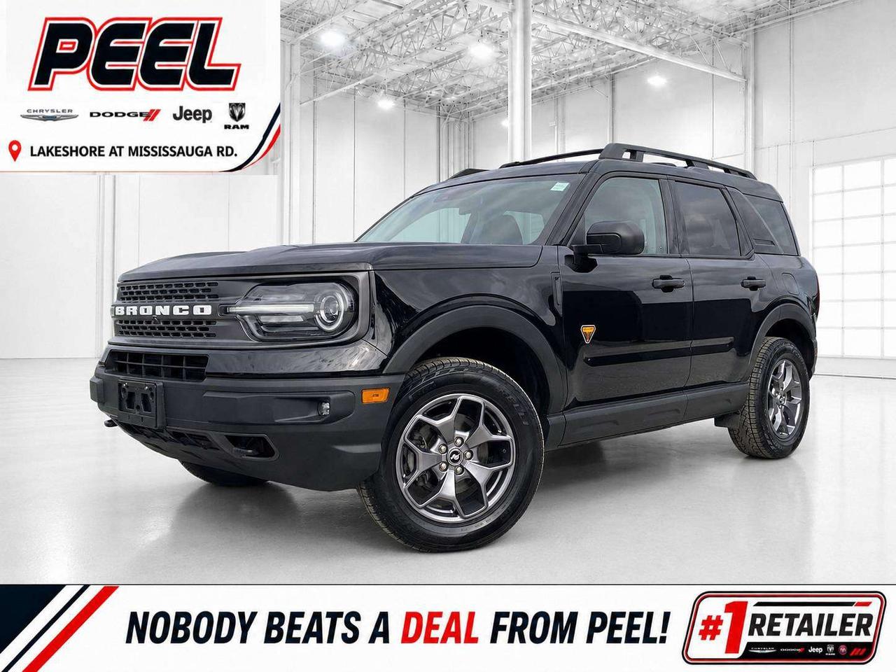 COME SEE WHY NOBODY BEATS A DEAL FROM PEEL! Your Source for ALL make and models used cars and trucks. 2024 Ford Bronco Sport Badlands 4X4 | 2.0L EcoBoost Turbocharged Engine | 250 HP | Shadow Black | Ebony & Area 51 Unique Cloth Seats | Heated Front Seats | Power Driver Seat with Lumbar Support | Remote Start | Intelligent Access with Push-Button Start | SYNC 3 Touchscreen Display | Apple CarPlay & Android Auto | SiriusXM Satellite Radio | Dual-Zone Automatic Climate Control | 110-Volt Power Outlet | FordPass Connect | Advanced 4X4 System | Twin-Clutch Rear Drive Unit | Terrain Management System with G.O.A.T. Modes | Trail Control | Off-Road-Tuned Suspension | Underbody Skid Plates | Front Tow Hooks | Hill Start Assist | Pre-Collision Assist with Automatic Emergency Braking | Lane Keeping System | Rear Parking Sensors | Rear Back-Up Camera | Automatic High Beams | Rain-Sensing Wipers | LED Headlights & Fog Lamps | Heated Power Mirrors | Roof Rails | Flip-Up Rear Liftgate Glass | 17-Inch Badlands Aluminum Wheels This 2024 Ford Bronco Sport Badlands is the model to choose for buyers who want genuine capability rather than simply the Bronco look. Finished in Shadow Black with the distinctive Ebony and Area 51 interior, it has a rugged, purposeful appearance that perfectly suits its off-road hardware. The Badlands-exclusive 2.0L EcoBoost engine delivers stronger performance than the standard Bronco Sport powertrain, while its specialized 4X4 system, Terrain Management System, protective skid plates, and red front recovery hooks provide real confidence on snowy roads, cottage trails, and rough terrain. It is also exceptionally easy to live with every day, offering automatic climate control, remote start, a power driver seat with lumbar support, SYNC 3, FordPass connectivity, rear parking sensors, and a rear camera. Pre-collision assist, automatic emergency braking, and lane-keeping technology add further confidence, while the roof rails, flip-up rear glass, and flexible cargo area make it ready for bikes, camping equipment, pets, and weekend adventures. This is a sharp, capable, and strong-value Badlands with the performance and equipment that distinguish it from an ordinary compact SUV. ______________________________________________________ FREE CarFax included! Click the CarFax link in the listing to view the report. Our advertised prices are for consumers/end users only and are not intended for dealer, wholesale, exporter, or broker purchases. ______________________________________________________ Peel Chrysler is based in Port Credit, Mississauga, and proudly serves customers across Ontario and Canada, including Toronto, Oakville, North York, Richmond Hill, Ajax, Hamilton, Niagara Falls, Brampton, Scarborough, Vaughan, London, Windsor, Cambridge, Kitchener, Waterloo, Brantford, Sarnia, Pickering, Huntsville, Milton, Woodbridge, Aurora, Newmarket, Orangeville, Georgetown, Markham, North Bay, Sudbury, Barrie, Oshawa, Kingston, Innisfil, and surrounding areas. Browse our selection of used cars, trucks, SUVs, vans, Ram, Jeep, Dodge, Chrysler, FIAT, and all makes and models at peelchrysler.com. ______________________________________________________ Disclaimer: Prices are for consumer/end-user purchases only. Advertised prices are all-in and include all dealer fees and charges, including the $599 loan processing fee where applicable, except HST, Fuel and Licensing, unless otherwise stated. Payments, rates, and terms are subject to approved credit and may change without notice. If a trade-in has an outstanding loan balance and Peel Chrysler is required to facilitate the lien payout, a $349 lien payout fee applies. Most pre-owned vehicles originally come with two keys; however, all Peel Chrysler pre-owned vehicles come standard with one key unless otherwise stated. Vehicle images may be digitally adjusted or enhanced for presentation purposes and may not always reflect the exact appearance of the vehicle. While we make every effort to ensure accuracy, vehicle details, features, options, materials, history, specifications, pricing, availability, and CarFax information should be verified with Peel Chrysler before purchase.