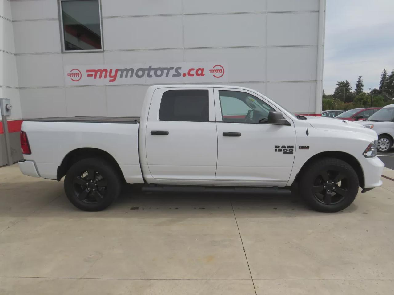 2021 RAM 1500 Classic Express | 4WD | Automatic | Crew Cab | Short Bed | Night Edition | Alloy Wheels | Heated Seats | Heated Steering Wheel | Power Driver Seat | Multi-Zone Climate Control | Android Auto & Apple CarPlay | Bluetooth | Back-Up Camera | Remote Start | Auto-Dimmi Photo