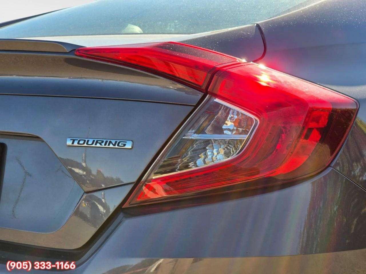 2019 Honda Civic Touring Apple CarPlay & Android Auto • Power Sunroof • Leather Seating • Built-In Navigation System • Remote Start System Photo