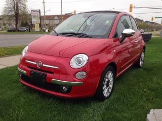 2014 Fiat 500c Lounge ***REMOTE KEYLESS ENTRY***ELECTRONIC POWER STEERING***AUTO-DIMMING REARVIEW MIRRORS***POWER RETRACTABLE SOFT TOP***REAR PARK ASSIST***TINTED WINDSHIELD***LEATHER-FACED SEATING***HEIGHT-ADJUSTABLE DRIVERS SEAT***POWER WINDOWS &LOCKS***AUTOMATIC TEMPERATURE CONTROL***TILT STEERING COLUMN***REAR 50/50 SPLIT-FOLDING SEAT***MEDIA HUB with AUXILIARY INPUT and USB PORT***SIRIUS SATELLITE RADIO***BLUE& ME HANDSFREE COMMUNICATION***REAR CARGO SHELF PANEL***HEATED FRONT SEATSDiscerning drivers will appreciate the 2014 FIAT 500c! Fun. From the top down! This 2 door, 4 passenger convertible has not yet reached the 20,000 kilometer mark! Top features include front fog lights, heated door mirrors, a power convertible roof, and a split folding rear seat. Smooth gearshifts are achieved thanks to the efficient 4 cylinder engine, and for added security, dynamic Stability Control supplements the drivetrain. We have the vehicle youve been searching for at a price you can afford. Please dont hesitate to give us a call.