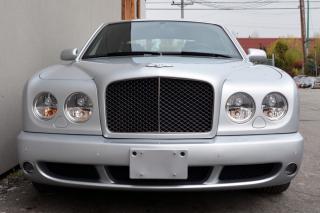 A local accident free Bentley Arnage T Sedan. Well equipped with Diamond stitched seating surfaces and door panel inserts, Heated power leather front memory seats, Heated power leather rear seats, Dual zone climate control, Power tilt moonroof, Navigation, 6 Disc CD changer, Power tilt steering wheel, Power windows, Power door locks, Power folding mirrors, Cruise control, Keyless entry, Push button ignition, Wood trim, Engine turned aluminum door trim inserts, Leather headliner / dash, Front and rear parking sensors, HID Headlamps, Fog lamps, Headlamp washing system, 19 5-Spoke polished alloy wheels. 6.75L Twin turbo V8 mated to a 6 speed shiftable automatic transmission rated by the factory at 500hp / 738lb-ft. A 1 year warranty is included in the purchase price of this vehicle. Well maintained and just fully serviced by Bentley Vancouver. Leasing and financing available. All trades accepted. Viewing by appointment Dealer # 10290 null