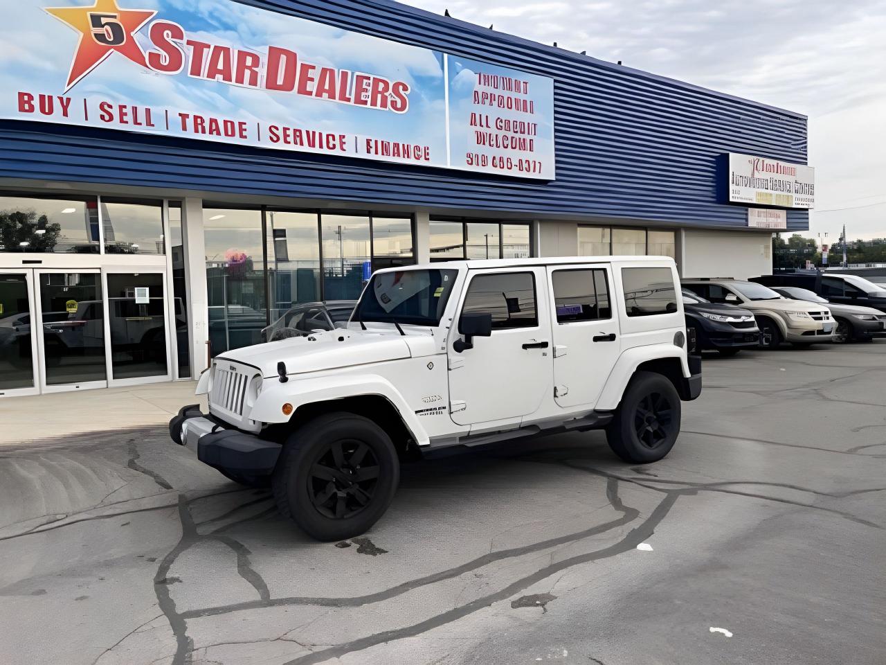 CERTIFIED V6 MUST SEE MATCH COLOUR TOP BLACK WHEELS  MINT CONDITION FULLY LOADED! WE FINANCE ALL CREDIT! 700+ VEHICLES IN STOCK
EXTRA OPTIONAL EQUIPMENT NAVIGATION  AND MORE GOOD LOOKING JEEP SAHARA 
Customer Preferred Package 23G      
 Connectivity Group                                     
Tire Pressure Monitoring Display          
 Handsfree Communication              
 Vehicle Information Center          
 Dual Top Group                                       
Black Sunrider Soft Top               
Sunrider Soft Top                        
 Body Color 3Piece Hard Top                                
Uconnect 430N CD/DVD/MP3/HDD/NAV                         
40GB Hard Drive w/28GB Available                
 6.5" Touch Screen Display                    
 GPS Navigation                        
 SIRIUS Satellite Radio                              
Instant Financing Approvals CALL OR TEXT 519+702+8888! Our Team will secure the Best Interest Rate from over 30 Auto Financing Lenders that can get you APPROVED! We also have access to in-house financing and leasing to help restore your credit.
Financing available for all credit types! Whether you have Great Credit, No Credit, Slow Credit, Bad Credit, Been Bankrupt, On Disability, Or on a Pension,  for your car loan Guaranteed! For Your No Hassle, Same Day Auto Financing Approvals CALL OR TEXT 519+702+8888.
$0 down options available with low monthly payments! At times a down payment may be required for financing. Apply with Confidence at https://www.5stardealer.ca/finance-application/ Looking to just sell your vehicle? WE BUY EVERYTHING EVEN IF YOU DONT BUY OURS: https://www.5stardealer.ca/instant-cash-offer/
The price of the vehicle includes a $480 administration charge. HST and Licensing costs are extra.
*Standard Equipment is the default equipment supplied for the Make and Model of this vehicle but may not represent the final vehicle with additional/altered or fewer equipment options.