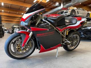 A local accident free Ducati 996S. 1 of 201 996S for the 1999 model year, done up with full Ducati collaboration Carbon Dream factory race kit. Carbon Dream makes carbon fibre for Bugatti hyper cars amongst others. Well equipped with Full carbon fiber body panels, Carbon fiber tank, Carbon fiber fenders, Carbon fiber chain guard, Carbon fiber clutch cover, Tank protector, Tinted windscreen, Arrow exhaust system, Arrow steering damper, Ohlins suspension, Brembo brakes, 17 Brembo wheels with Pirelli superbike track tires, Box with carbon belly fairing/ mirrors / signal lights. 996cc L-Twin mated to a 6 speed manual transmission rated by the factory at 123hp / 73lb-ft. Well maintained and just serviced. Leasing and financing available. All trades accepted. 
 
 Viewing by appointment 
 Dealer # 10290 null