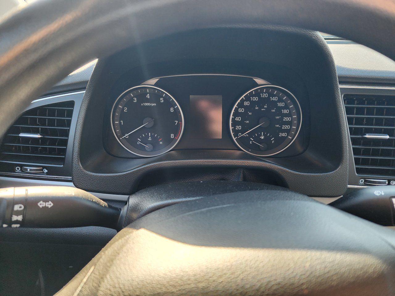 9873470