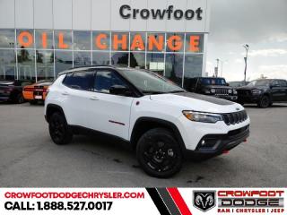 <b>Off-Road Package,  Blind Spot Detection,  Leather Seats,  4G Wi-Fi,  Heated Steering Wheel!</b><br> <br> <br> <br>  This 2023 Jeep Compass features gorgeous styling and introduces new innovative ways to enhance your driving experience. <br> <br>Keeping with quintessential Jeep engineering, this 2023 Compass sports a striking exterior design, with an extremely refined interior, loaded with the latest and greatest safety, infotainment and convenience technology. This SUV also has the off-road prowess to booth, with rugged build quality and great reliability to ensure that you get to your destination and back, as many times as you want. <br> <br> This bright white SUV  has an automatic transmission and is powered by a  200HP 2.0L 4 Cylinder Engine.<br> <br> Our Compasss trim level is Trailhawk. This rugged Compass Trailhawk comes prepped with a comprehensive off-road package that includes beefy suspension, 4 skid plates for undercarriage protection and black aluminum wheels with a full-size under-cargo mounted spare, along with front fog lamps, LED headlights with automatic high beams and cornering function, roof rack rails, and front and rear bumper tow hooks. The standard features continue with heated and power-adjustable front seats with driver lumbar support, a heated steering wheel, cloth/leather seating upholstery, remote engine start, proximity keyless entry, dual-zone front automatic air conditioning, and a 10.1-inch infotainment screen with Apple CarPlay and Android Auto. Safety features also include blind spot detection, forward collision warning with active braking and rear cross-path detection, lane keeping assist with lane departure warning, rear parking sensors, and a rearview camera. This vehicle has been upgraded with the following features: Off-road Package,  Blind Spot Detection,  Leather Seats,  4g Wi-fi,  Heated Steering Wheel,  Remote Start,  Proximity Key. <br><br> <br>To apply right now for financing use this link : <a href=https://www.crowfootdodgechrysler.com/tools/autoverify/finance.htm target=_blank>https://www.crowfootdodgechrysler.com/tools/autoverify/finance.htm</a><br><br> <br/> Total  cash rebate of $2609 is reflected in the price. Credit includes up to 5% of MSRP. <br> Buy this vehicle now for the lowest bi-weekly payment of <b>$305.81</b> with $0 down for 96 months @ 6.49% APR O.A.C. ( Plus GST  documentation fee    / Total Obligation of $63609  ).  Incentives expire 2024-02-29.  See dealer for details. <br> <br>We pride ourselves in consistently exceeding our customers expectations. Please dont hesitate to give us a call.<br> Come by and check out our fleet of 80+ used cars and trucks and 180+ new cars and trucks for sale in Calgary.  o~o